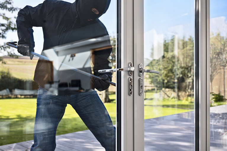 a robber breaking into a businesses front door